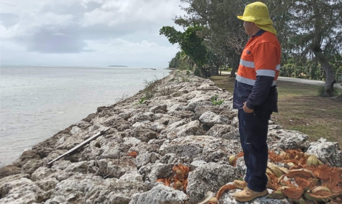 Staff members from the Lands Geospatial Information Systems (LGIS) geolocating the rock revetment in Kolonga.