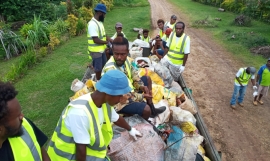 Photo of men collecting waste