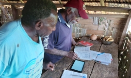 Noel Kaibaba and Philip Vanuau of Bamboo Bay, Malekula are entering turtle nest data into a new online smart-phone data collection app as part of the By-catch and Integrated Ecosystem Management (BIEM) Initiative in Vanuatu. Image Credit: Christopher Bartlett, Resilience